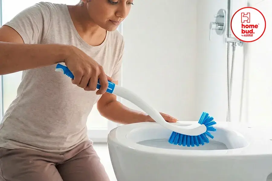 A women cleaning toilet from hockey brush